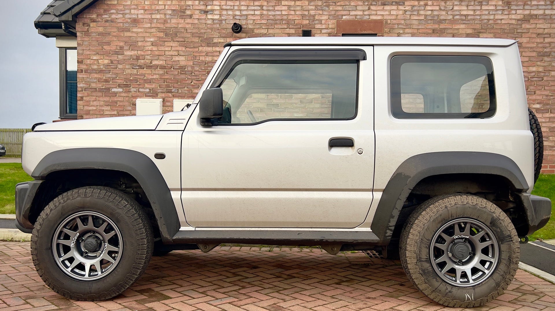 Silver Suzuki Jimny fitted with Anthracite EVO Corse DakarZero Wheels