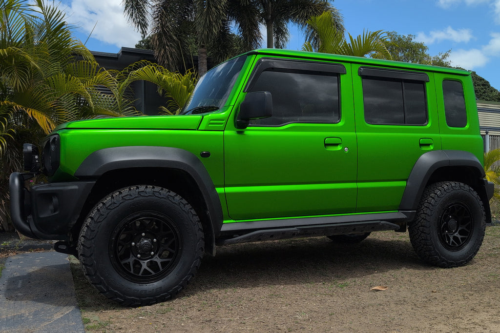 Green Suzuki Jimny (2023+) fitted with Satin Black Magpie M-01 Wheels