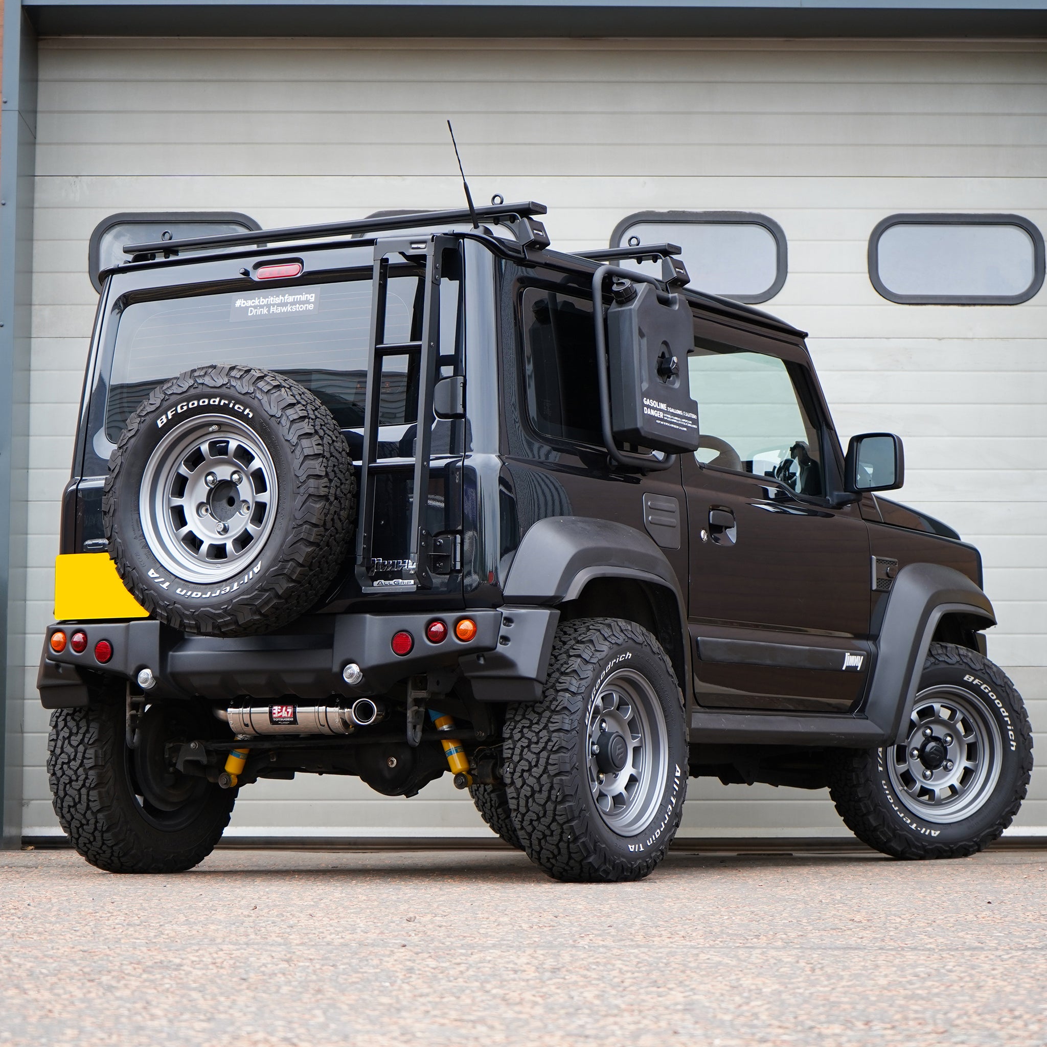Photo of a Suzuki Jimny with a painted APIO Tactical Rear Bumper for Suzuki Jimny JB74 (2018+) fitted with a Jimy exhaust upgrade. Jimny Body kit modification. 