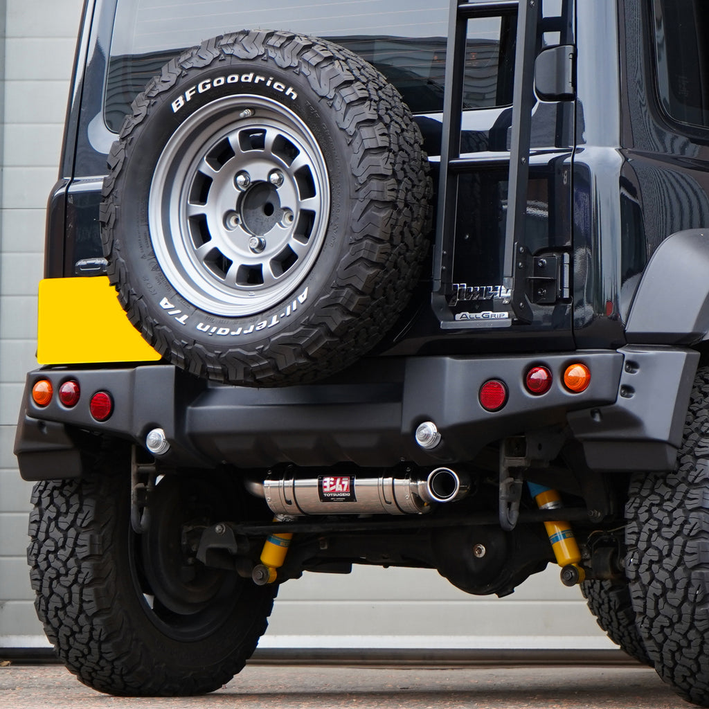 Photo of a Suzuki Jimny with a painted APIO Tactical Rear Bumper for Suzuki Jimny JB74 (2018+) fitted with a Jimy exhaust upgrade. Jimny Body kit modification. 