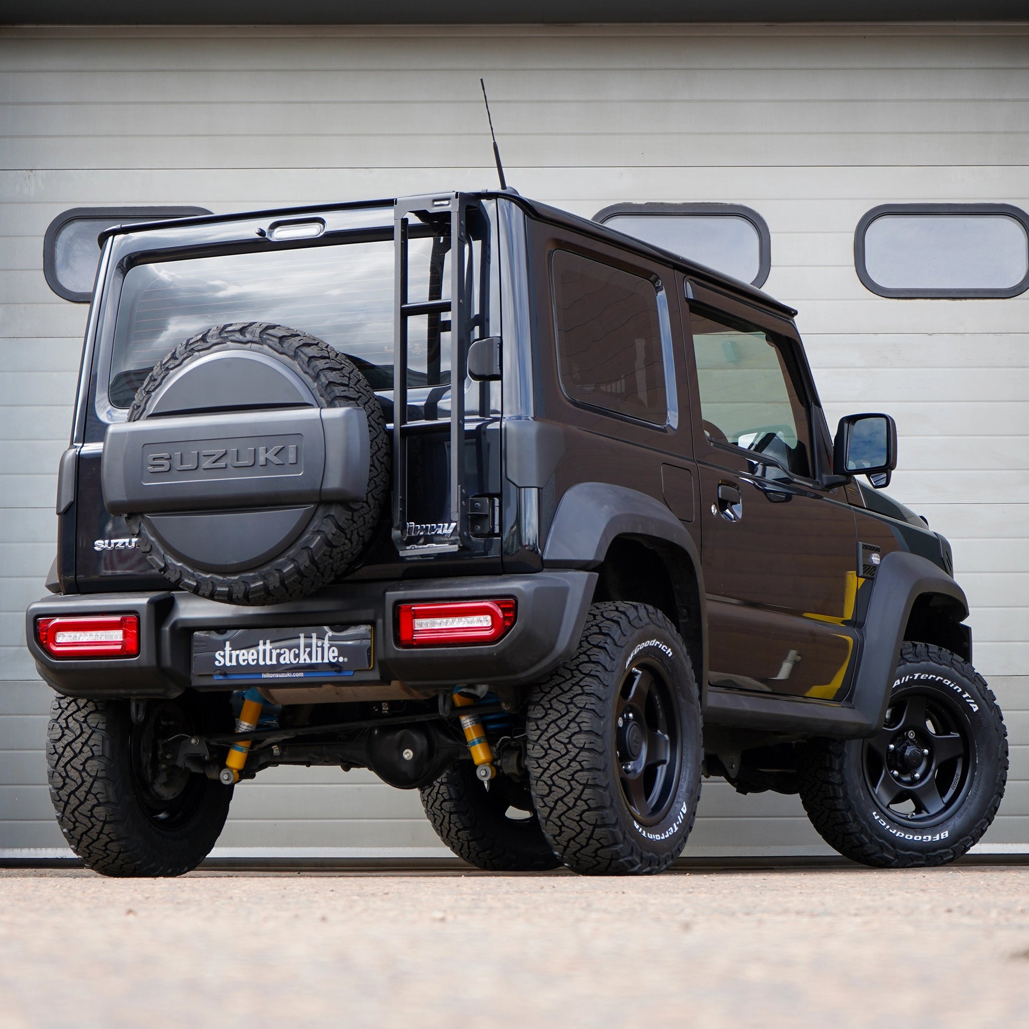 Black Suzuki Jimny with Bradley V wheels and jimnystyle adventure suspension lift kit +40MM suspension lift Jimny fitting service